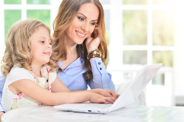 woman and little girl using   laptop - Foto, Imagen