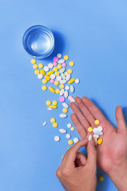 hand with pills and water - Photo, Image