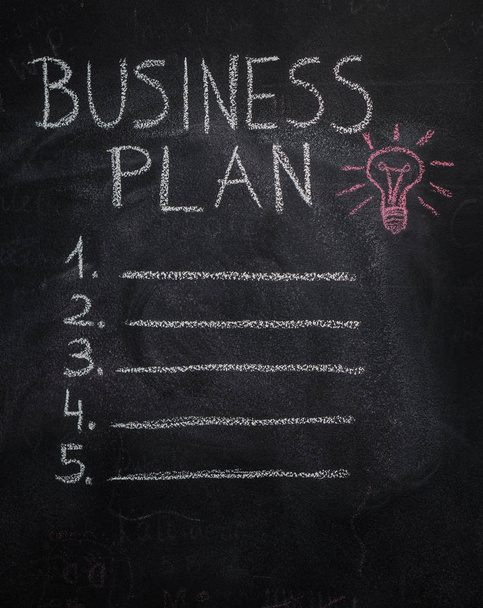 Business plan list and lightbulb on black chalkboard - Foto, Imagen