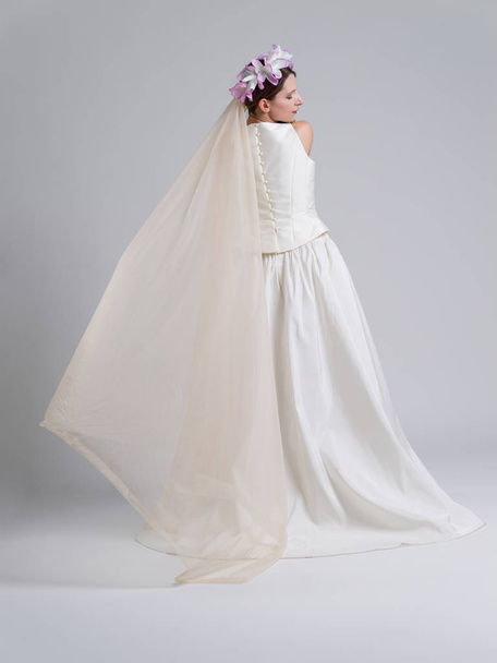 Rear view of a beautiful young woman in a wedding dress - Fotoğraf, Görsel
