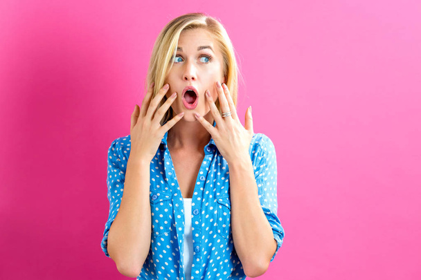 Surprised young woman posing - 写真・画像