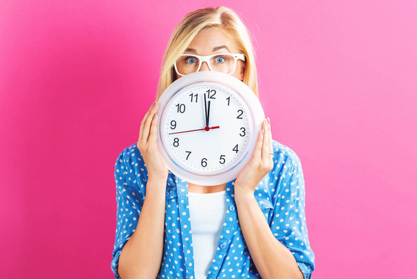  Woman holding clock showing nearly 12 - Photo, Image