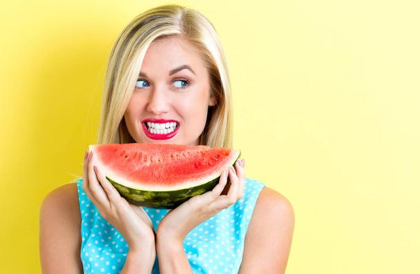 Happy young woman holding watermelon - Фото, изображение