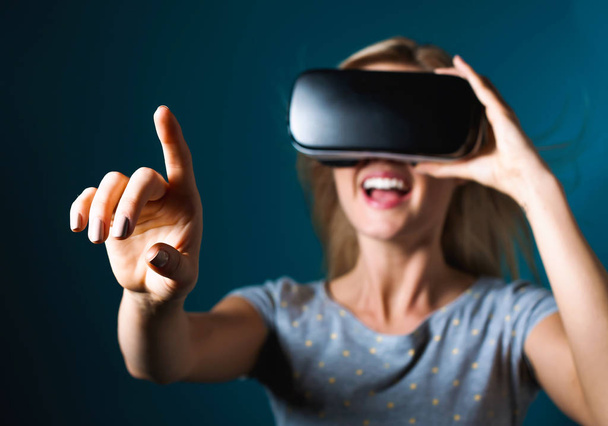Woman using a virtual reality headset - Фото, изображение