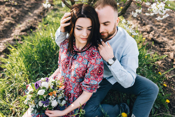 Young couple in the blooming garden - Foto, immagini