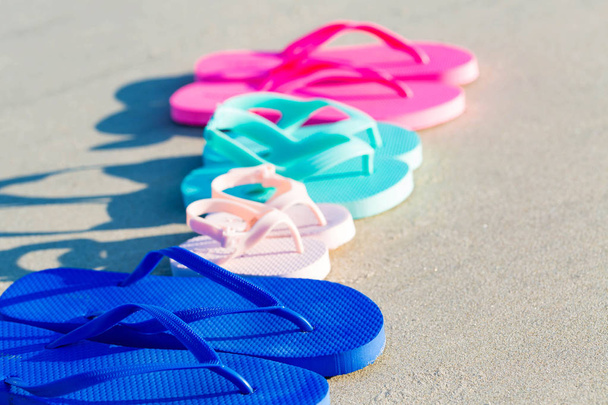 Colorful sandals at the beach - Фото, зображення