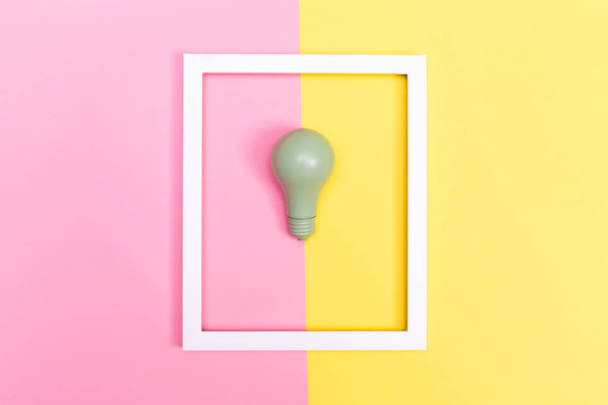 Colored lightbulb on a duotone background - Foto, Bild