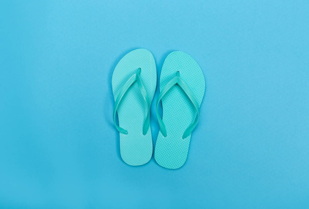 Beach sandals on a blue background - Fotoğraf, Görsel