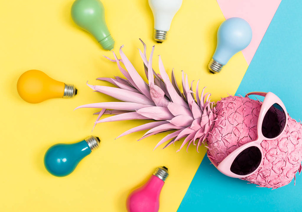Pink pineapple and colored lightbulbs - Foto, Imagen