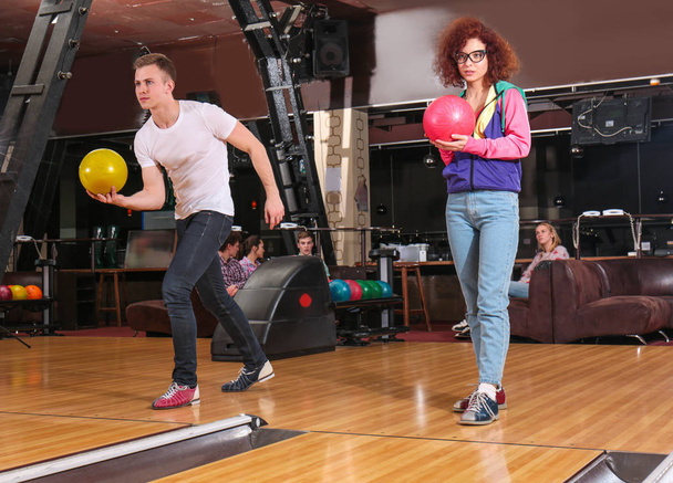 Friends having fun and playing bowling - Фото, изображение