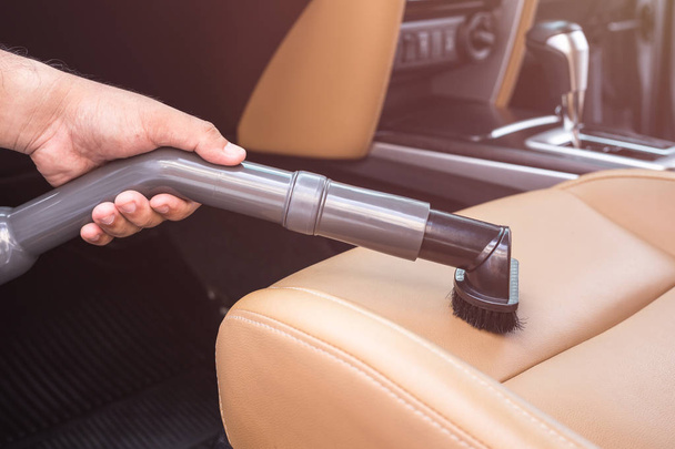 Hand of people holding vacuum cleaner and cleaning inside the SUV car - Φωτογραφία, εικόνα