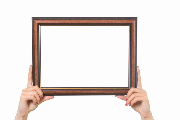 Frame in female hands on a white background - Foto, Imagem