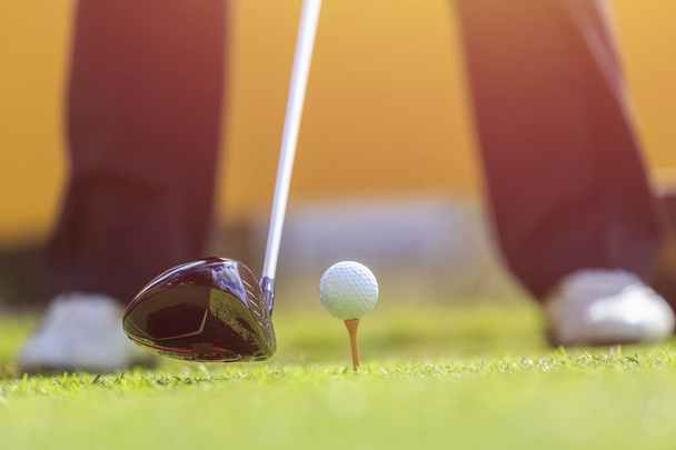 A man playing golf in green course. Focus on golf ball - Zdjęcie, obraz