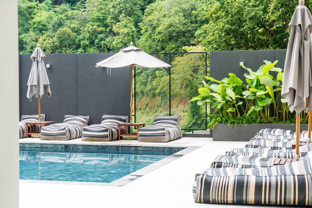 Beautiful luxury swimming pool in hotel pool resort  - Fotó, kép