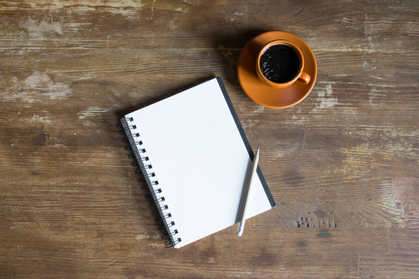 top view of notepad with pencil and coffee cup on wooden tabletop  - Photo, Image
