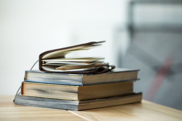 Close-up view of books and notebook with pencil on wooden table  - Photo, Image