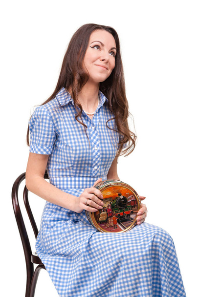 Beautiful girl sits on chair with box of chocolates in hands aga - Foto, Bild