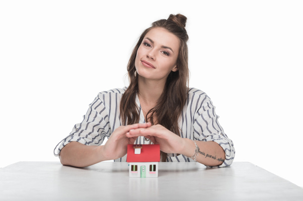 Young woman with house model  - Фото, изображение