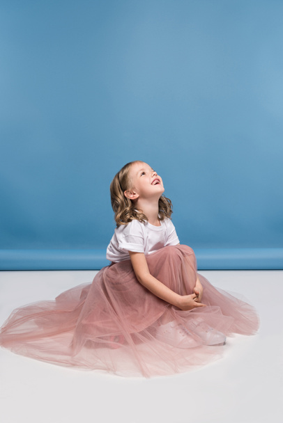 Little girl in pink skirt  - Фото, изображение