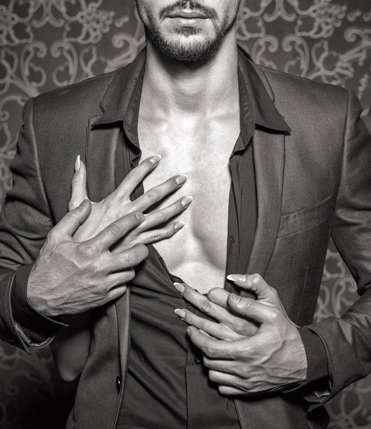 Sexy stylish rich man undressed by woman hands close seup, black an
 - Фото, изображение