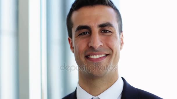 smiling businessman touching his hair at office - Felvétel, videó