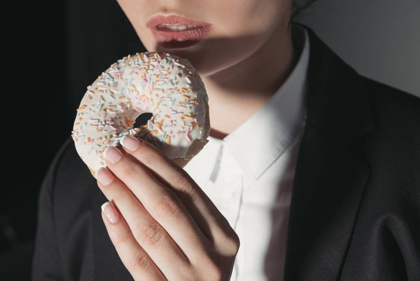 woman eating donut  - Фото, изображение