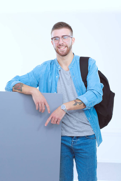Portrait of a smiling male student holding blank board. Educatio - Foto, afbeelding