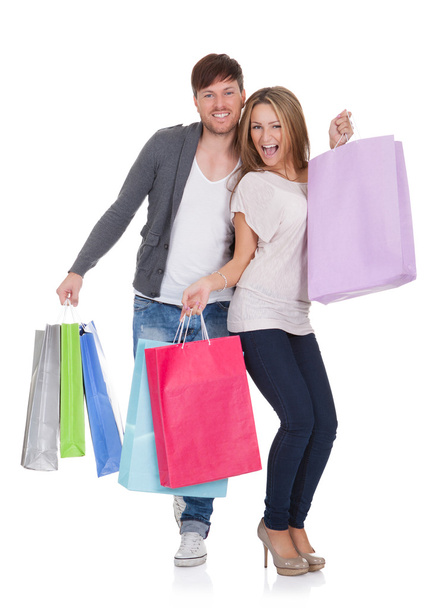 Guy and gal brings shopping bags - Foto, afbeelding