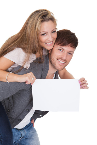 Woman getting a piggyback ride with blank sign - Foto, immagini