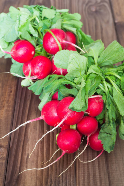 A bunch of radishes on a wooden table - Photo, Image