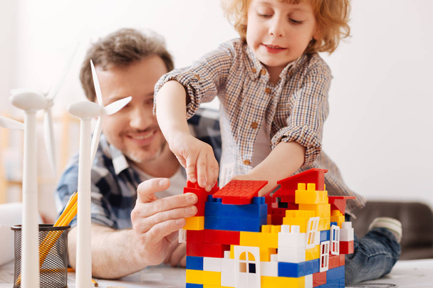 Serious boy building house while playing with erector set - Photo, Image