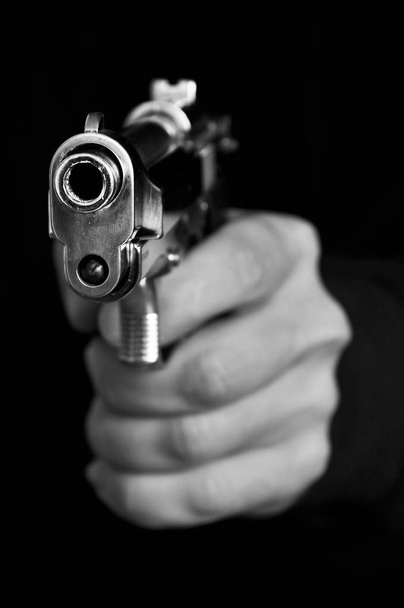 Man holding metal gun - Foto, imagen