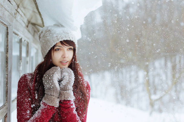 Portrait of attractive caucasian smiling happy woman with snow. Happy smiling girl. Girl with mittend play with snow and laugh. Good mood and good life concept. White healthy smile. - Photo, Image