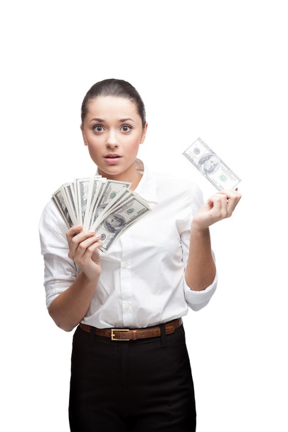 Young surprised businesswoman holding money - 写真・画像