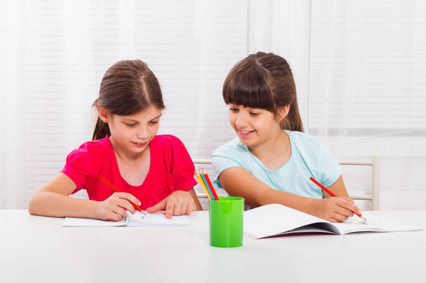 Little girls doing homework together - Foto, Imagen
