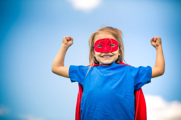 Funny little girl playing power super hero. - Foto, Imagen