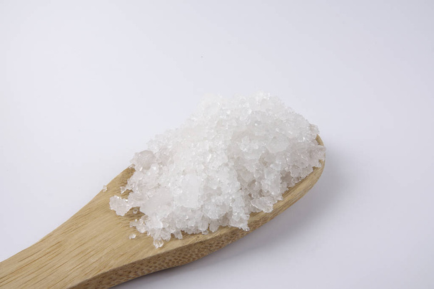 Sel marin dans une cuillère en bois. Aussi appelé sel de laurier ou sel solaire, est utilisé dans la cuisine et les cosmétiques. Cristaux de grains bruts du minéral
. - Photo, image