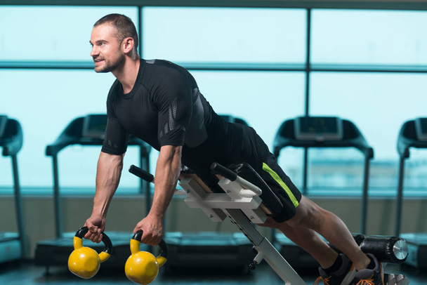 Man Doing Heavy Weight Exercise With Kettle-bell - Photo, Image