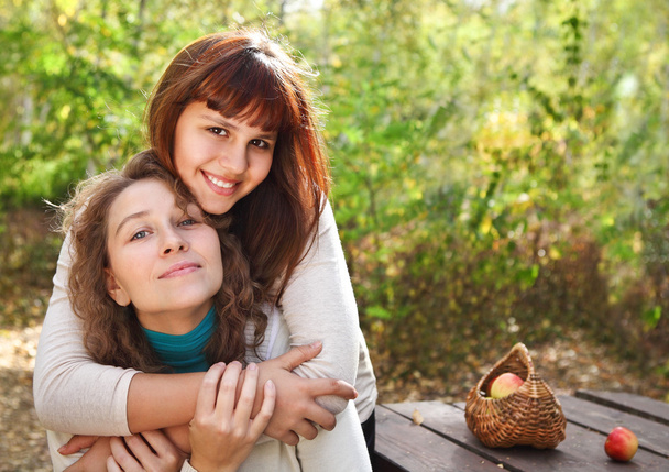 Young smiling woman with her teen daughter - Photo, Image