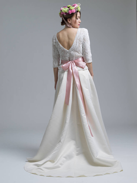 Rear view of a beautiful young woman in a wedding dress - Fotografie, Obrázek