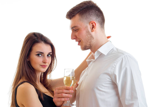 a close-up portrait of young man with a glass in hand and a woman - Foto, Bild