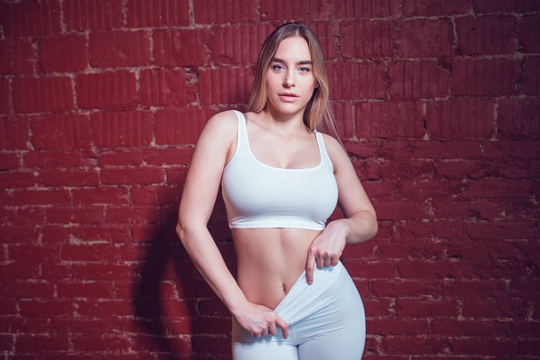 Sexy blonde woman with huge breast in a white top and leggings. Mock-up. - Φωτογραφία, εικόνα