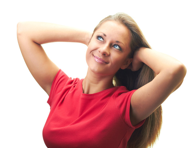 Attractive smiling young woman in a red shirt with her hands up - 写真・画像