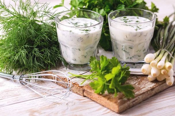 Ayran with fresh herbs. Traditional Turkish yoghurt drink. - Valokuva, kuva