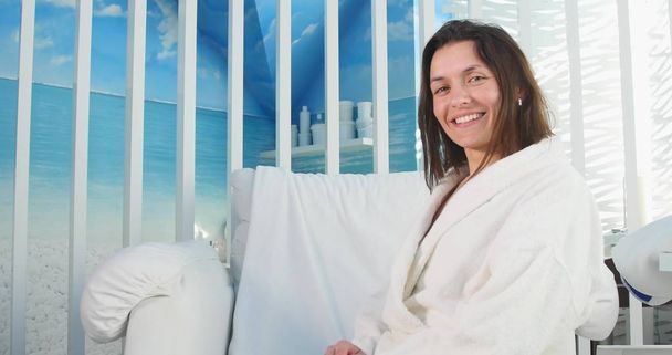 Portrait of smiling young woman in bathrobe - Zdjęcie, obraz