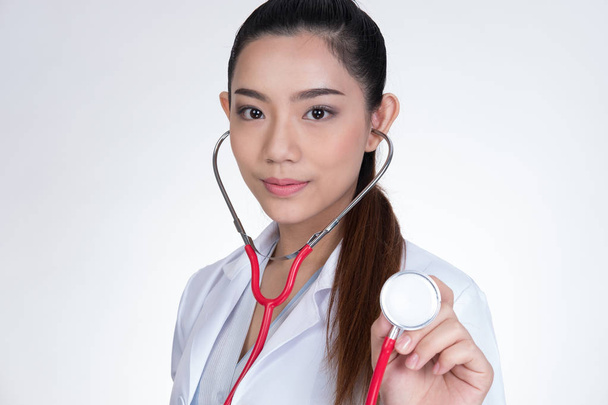 female doctor showing stethoscope for checkup over white backgro - Photo, Image