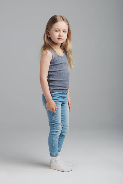 little girl studio portrait on grey background - Фото, изображение