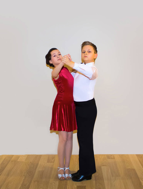 The young boy and girl posing at dance studio - Photo, Image
