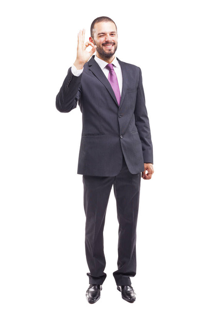 businessman gesturing OK sign and smiling - Foto, Imagen