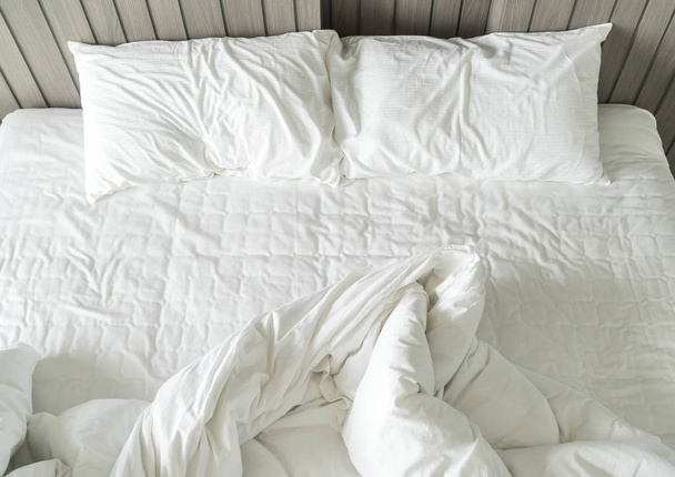 rumpled bed with white messy pillow decoration in bedroom  - Foto, Imagem